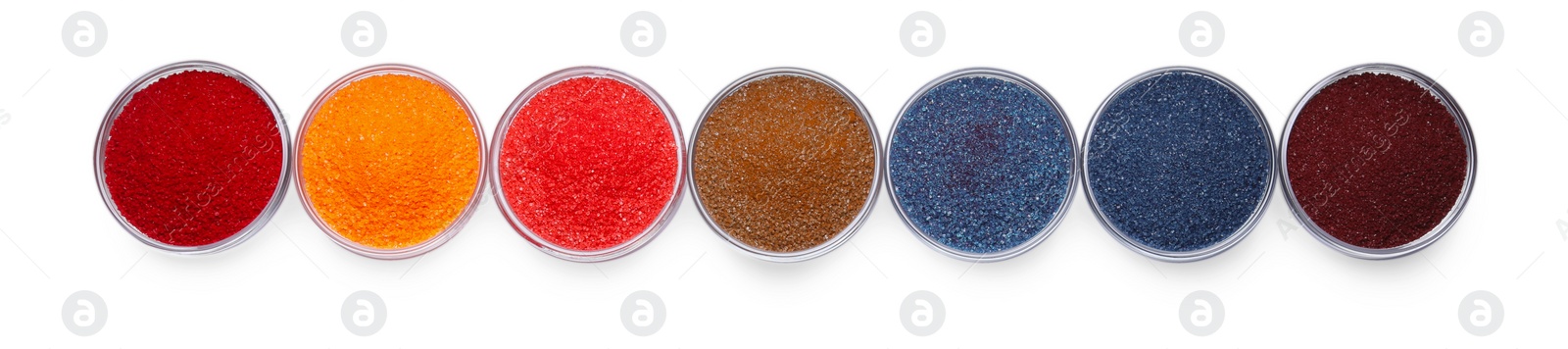 Photo of Glass bowls with different food coloring isolated on white, top view