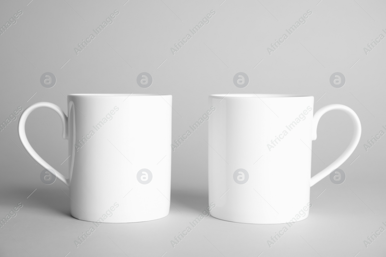 Photo of Ceramic cups on light background. Mock up for design