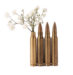 Bullets and cartridge case with beautiful gypsophila flowers isolated on white