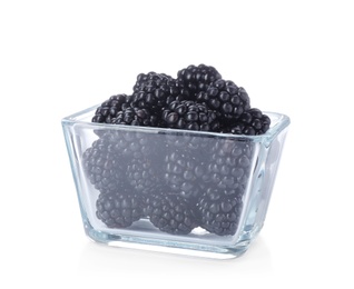 Glass bowl with blackberries on white background