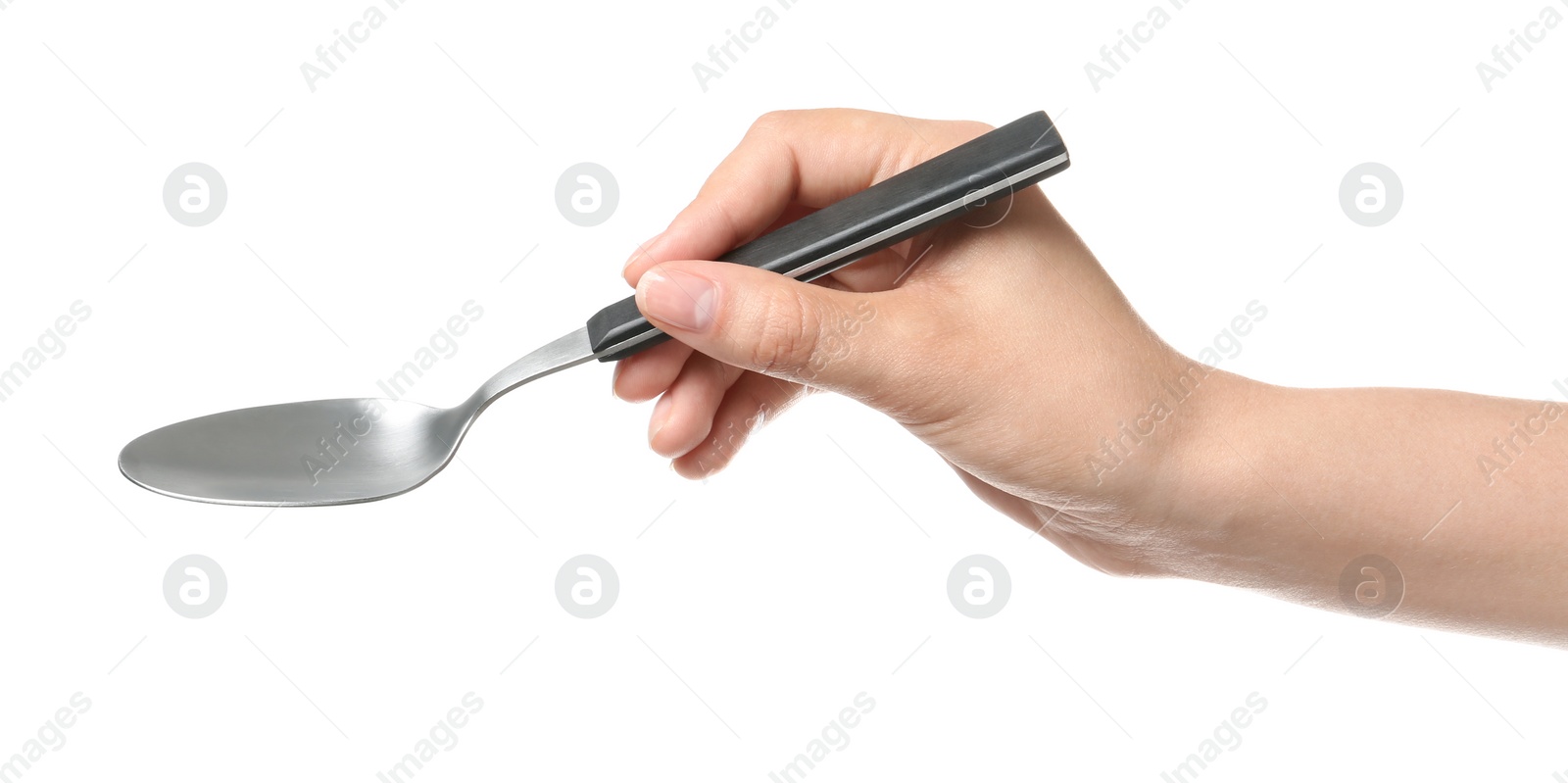 Photo of Woman holding clean tablespoon on white background, closeup