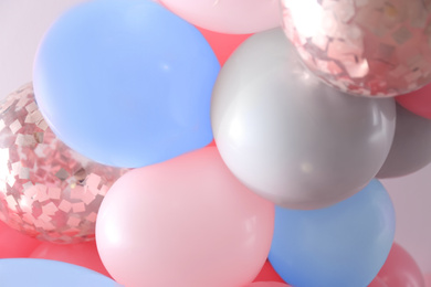 Image of Beautiful colorful balloons on light background, closeup. Party decor 