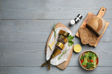Photo of Flat lay composition with smoked fish on light grey wooden table. Space for text