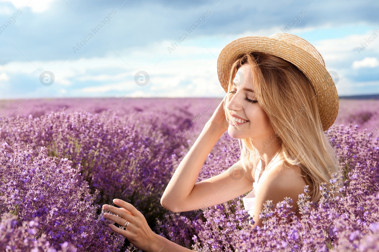 Photo of Young woman in lavender field on summer day