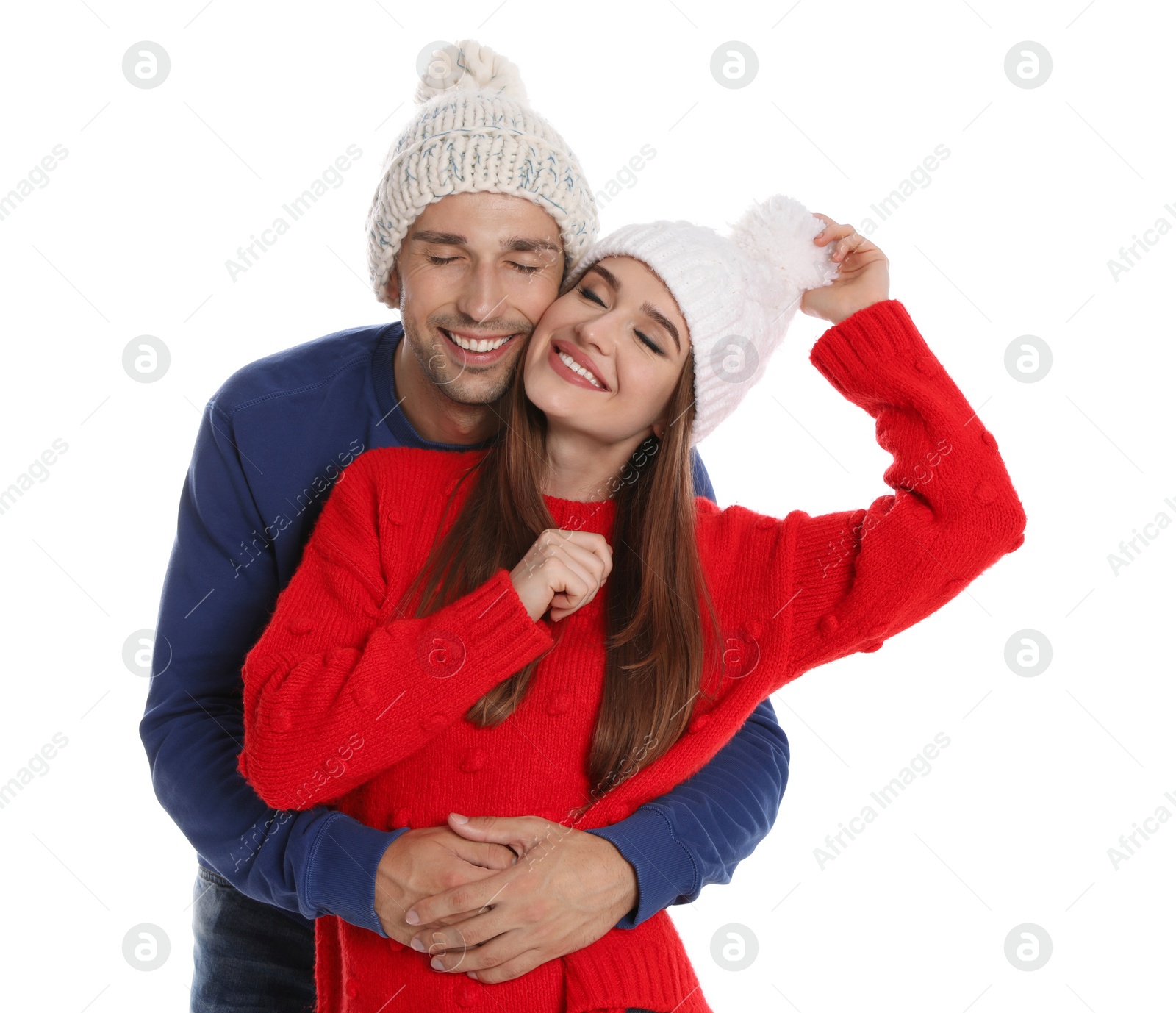 Photo of Happy young couple in warm clothes on white background. Winter season