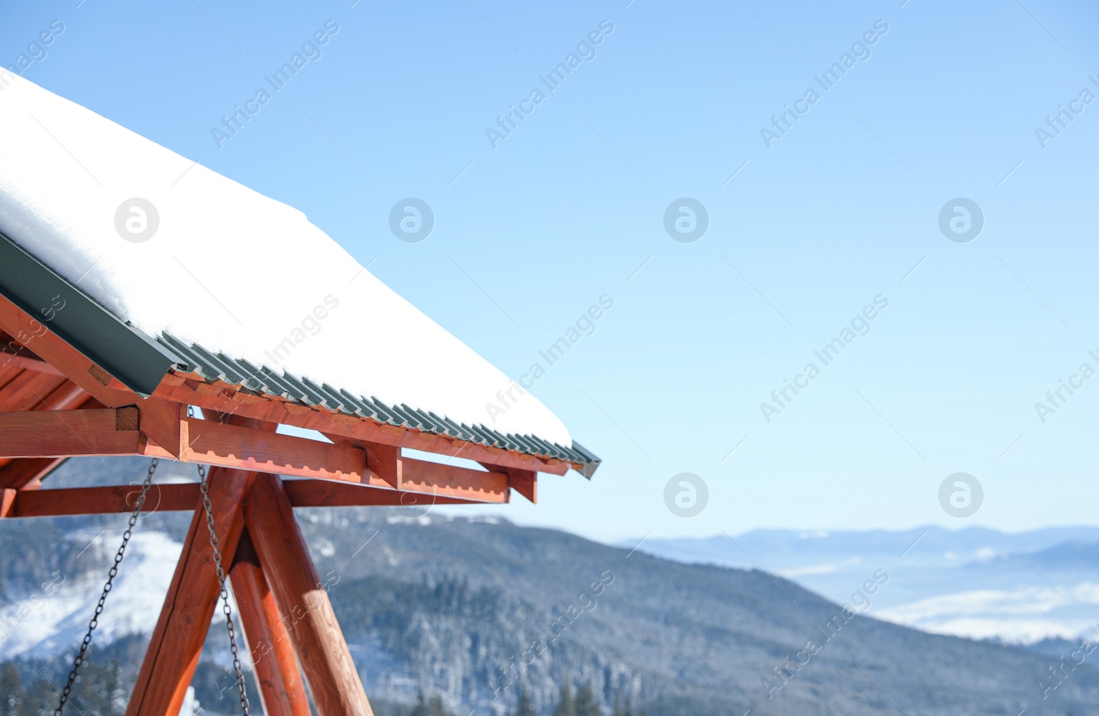 Photo of Wooden gazebo covered with snow in mountains. Winter vacation