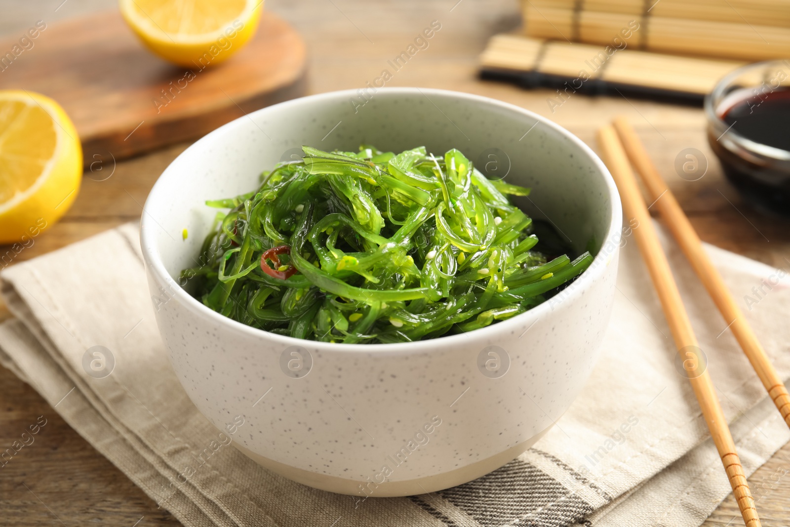 Photo of Japanese seaweed salad served on table, closeup