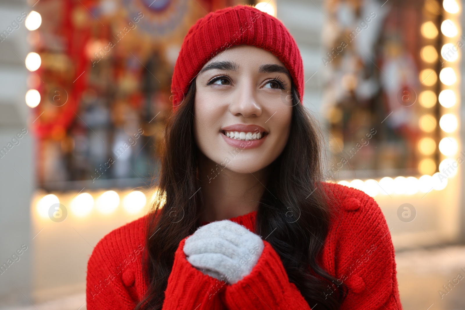 Photo of Portrait of smiling woman on blurred background. Winter time