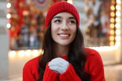 Photo of Portrait of smiling woman on blurred background. Winter time