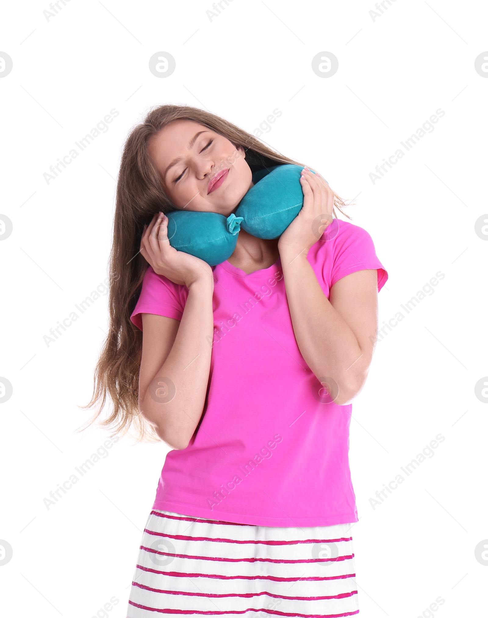 Photo of Happy young woman in pajamas with neck pillow on white background