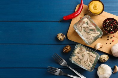 Photo of Delicious aspic with meat served on blue wooden table, flat lay. Space for text