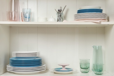 White shelving unit with set of dishware