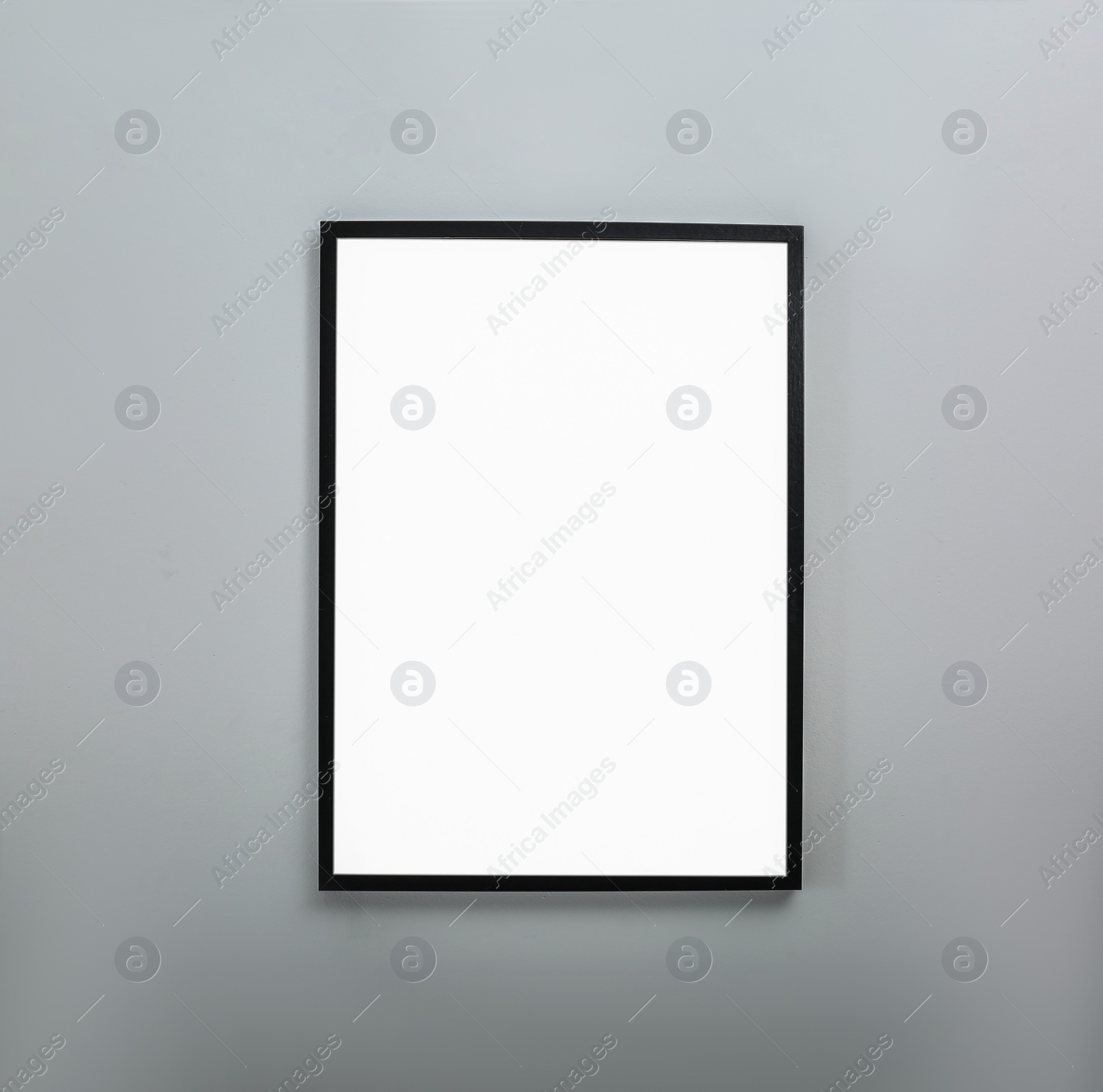 Photo of Frame with empty canvas on wall in modern art gallery. Mockup for design