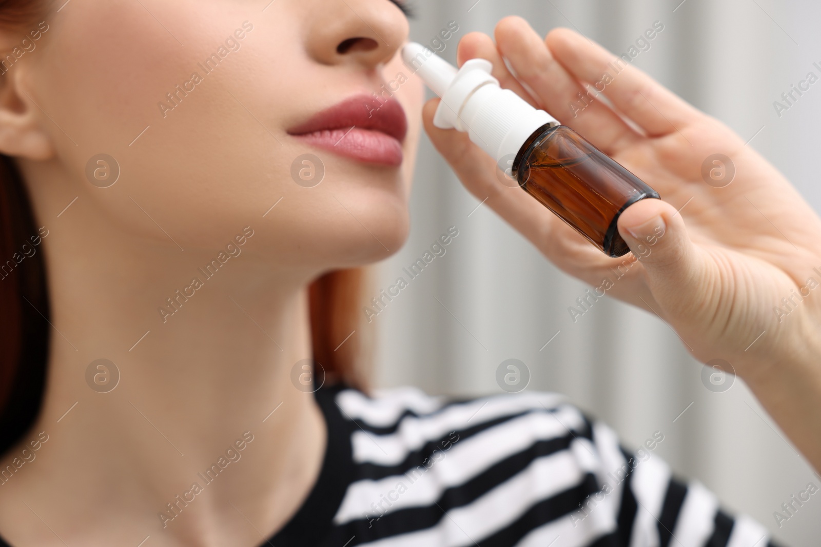 Photo of Medical drops. Woman using nasal spray at home, closeup