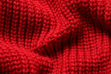 Photo of Texture of soft red knitted fabric as background, closeup
