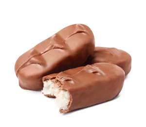 Photo of Delicious milk chocolate candy bars with coconut filling on white background