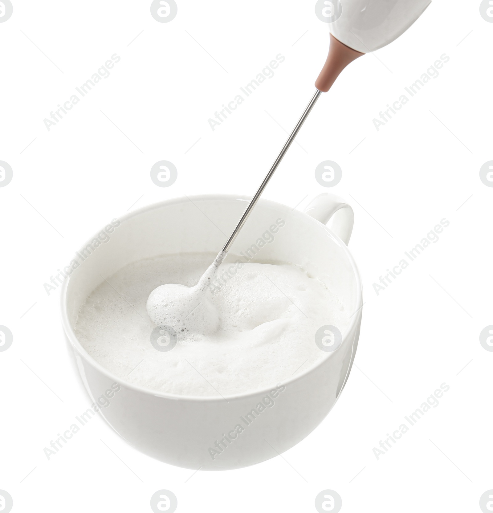 Photo of Whisking milk in cup with mini mixer (frother wand) isolated on white, closeup