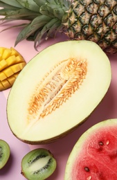 Photo of Juicy melon and other fruits on color background