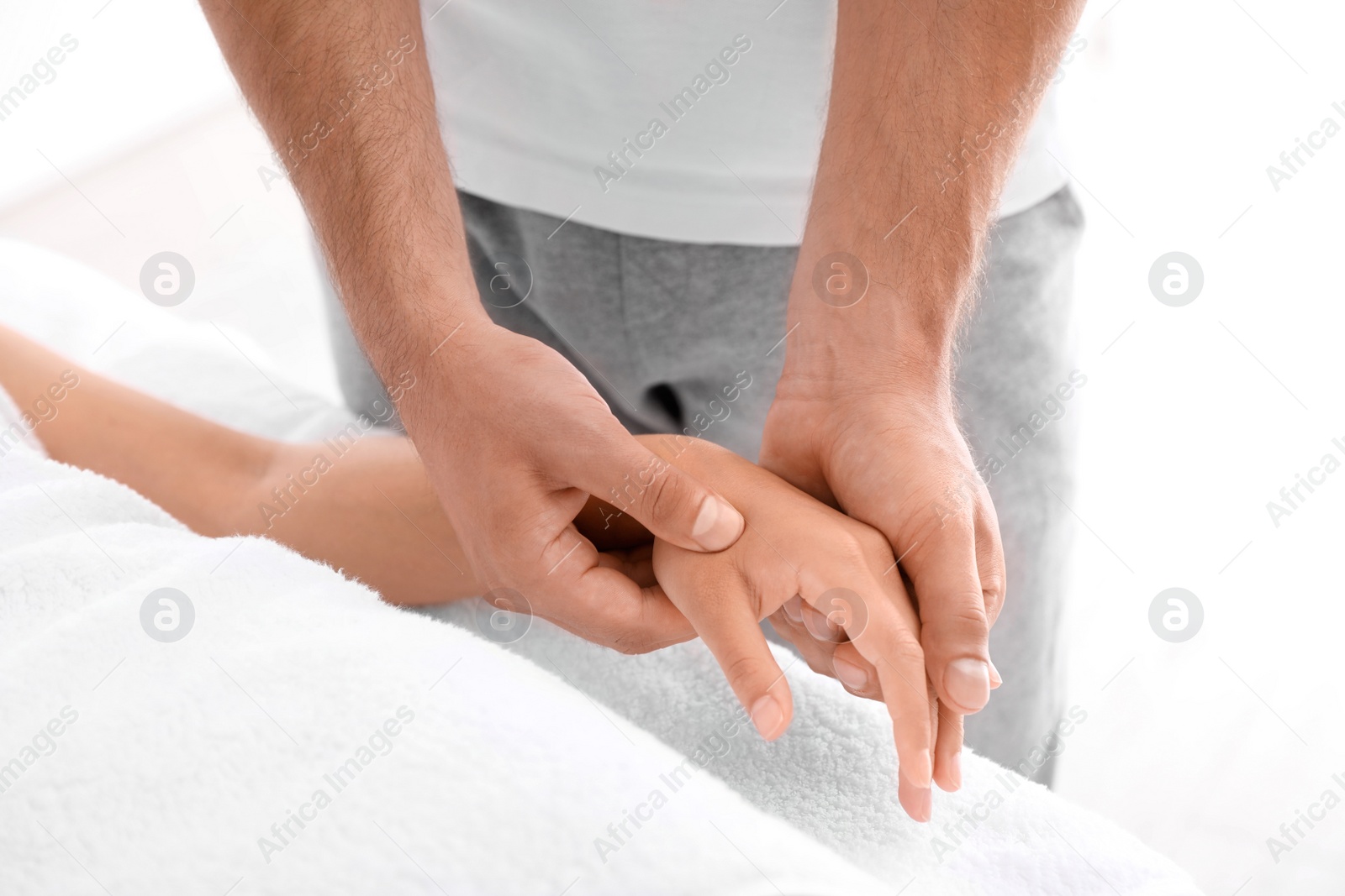 Photo of Young woman receiving massage in salon, closeup