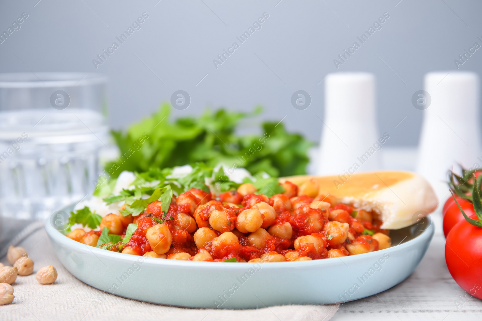 Photo of Plate with delicious chickpea curry on table, closeup