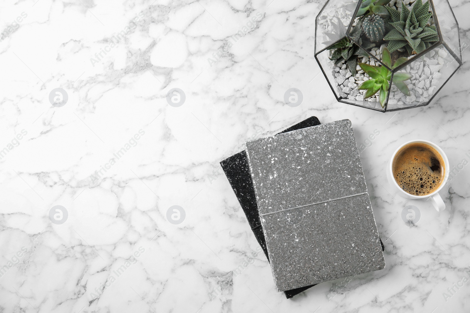 Photo of Flat lay composition with notebooks, coffee and succulents on marble table. Space for text