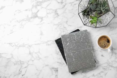 Photo of Flat lay composition with notebooks, coffee and succulents on marble table. Space for text