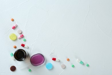 Photo of Flat lay composition with cough drops, syrup and pills on white background. Space for text