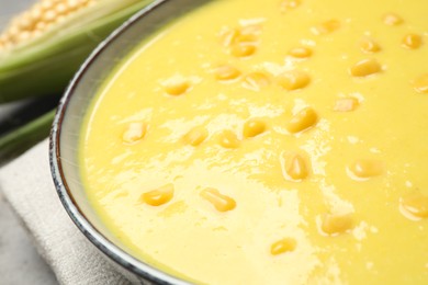 Photo of Delicious creamy corn soup on table, closeup