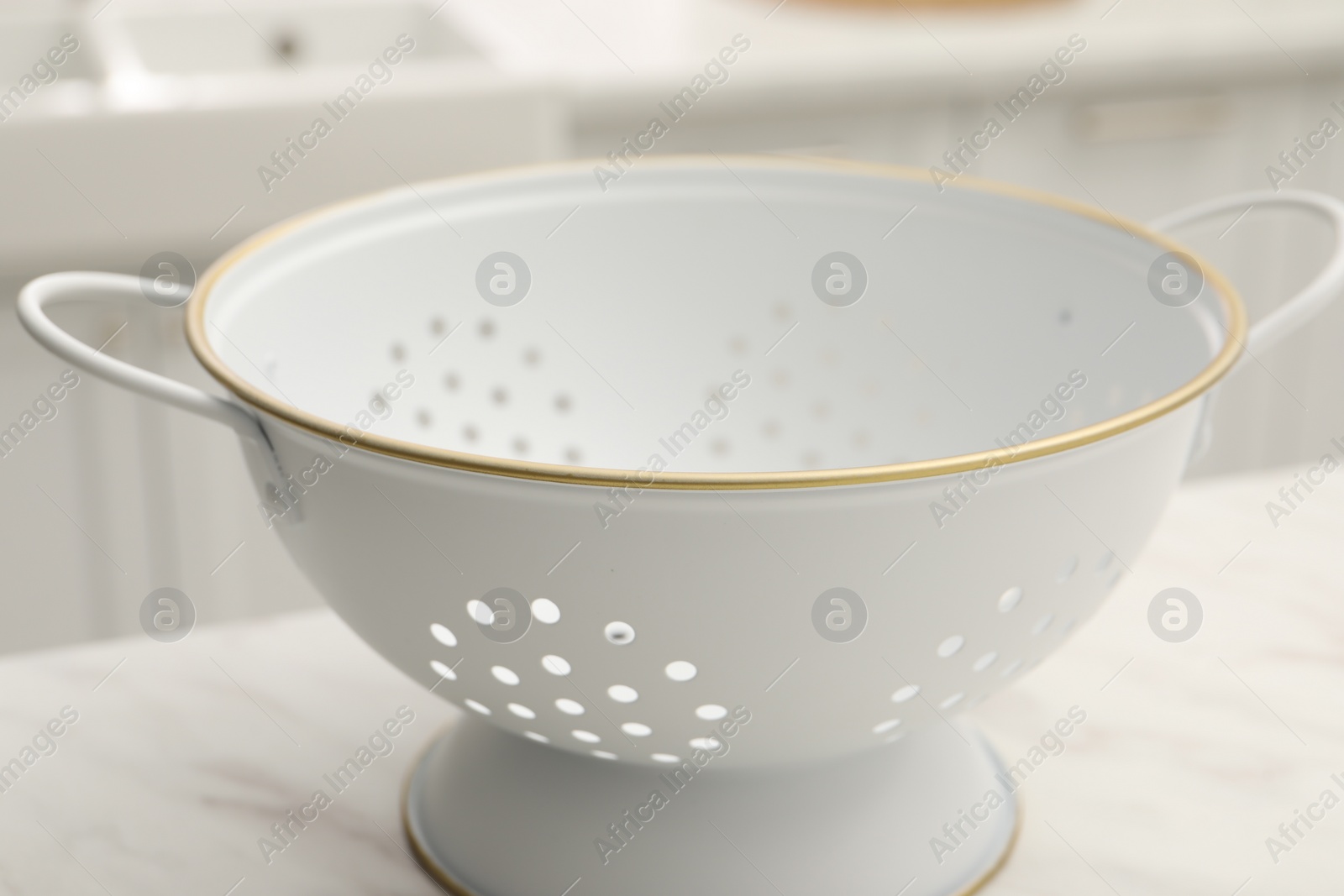 Photo of One clean colander on white table, closeup