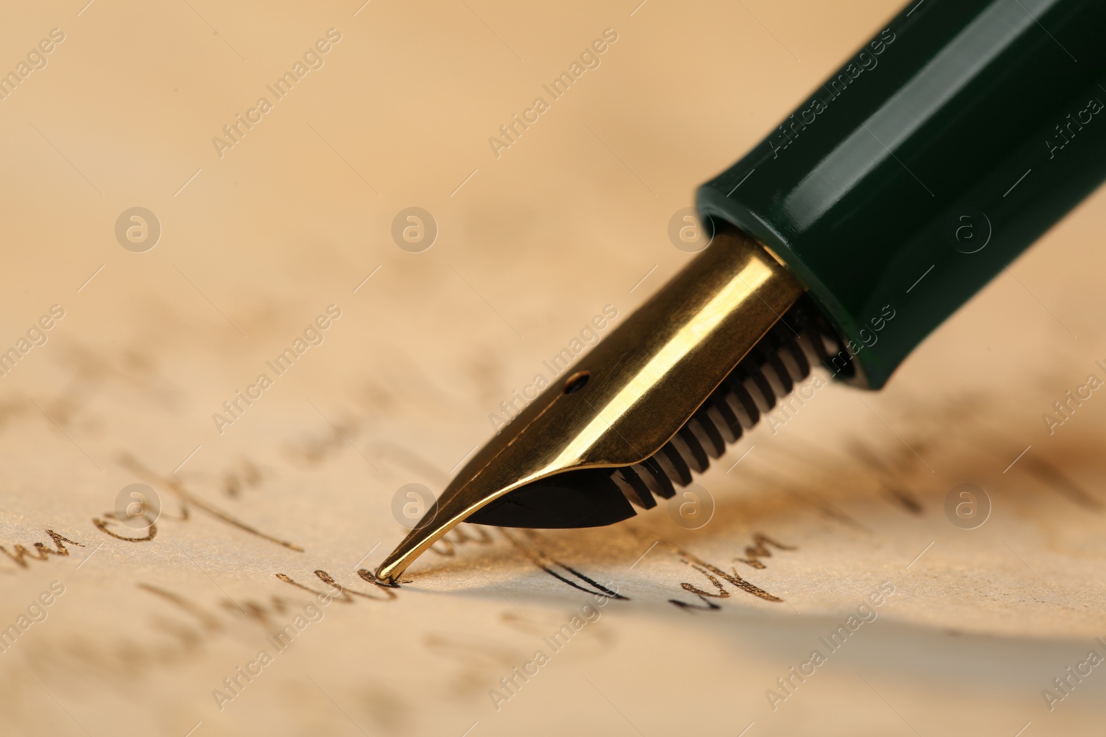 Photo of Writing letter with beautiful fountain pen, closeup