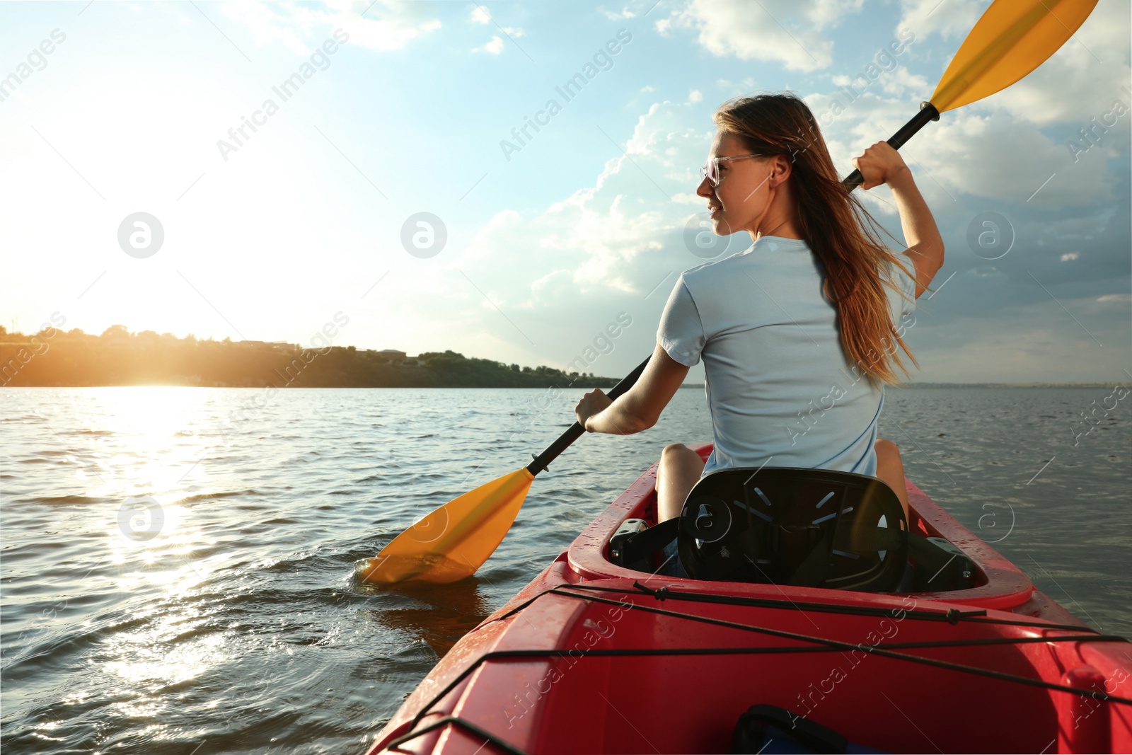 Photo of Happy woman kayaking on river, back view. Summer activity