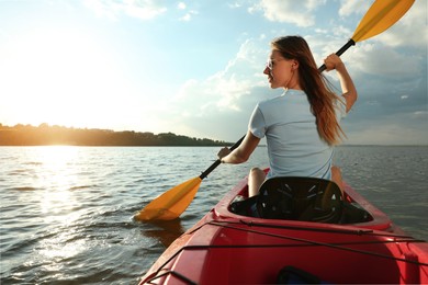 Photo of Happy woman kayaking on river, back view. Summer activity