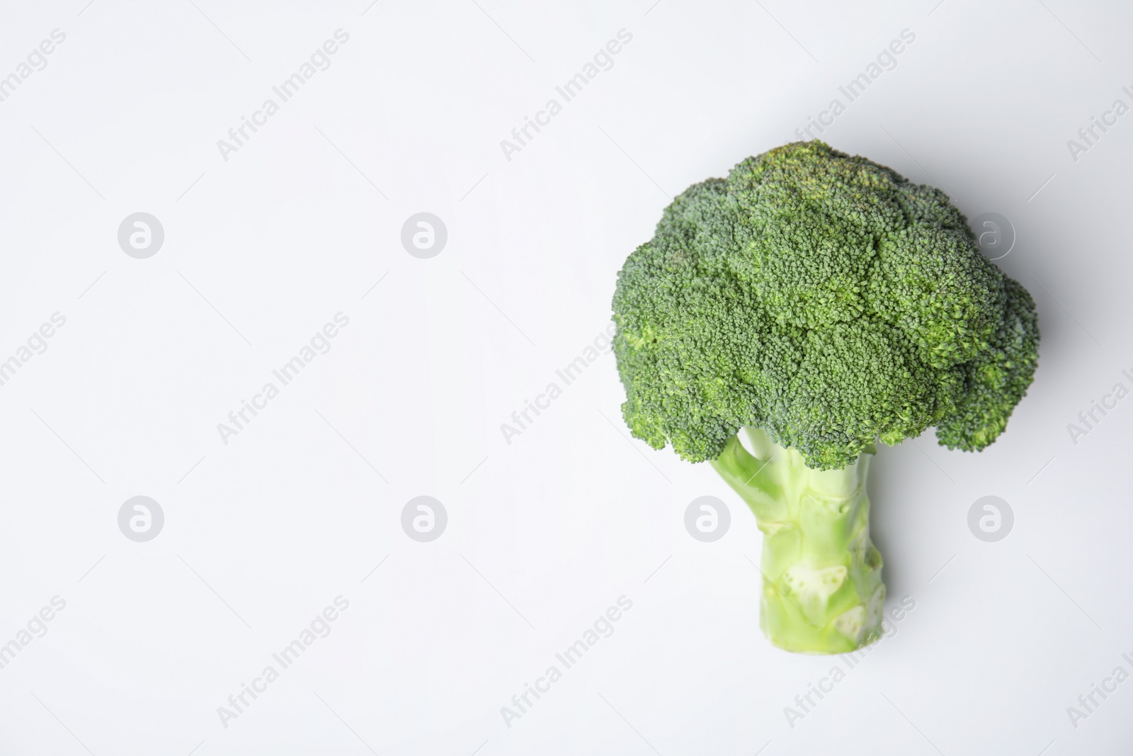 Photo of Fresh green broccoli on color background, top view. Space for text