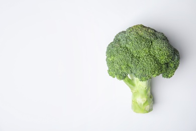 Photo of Fresh green broccoli on color background, top view. Space for text