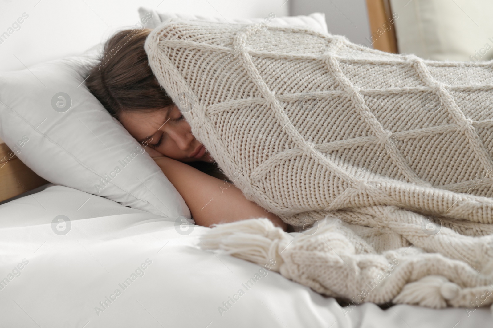 Photo of Sleepless young woman in bed at home