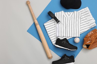 Photo of Flat lay composition with baseball uniform and sports equipment on color background. Space for text