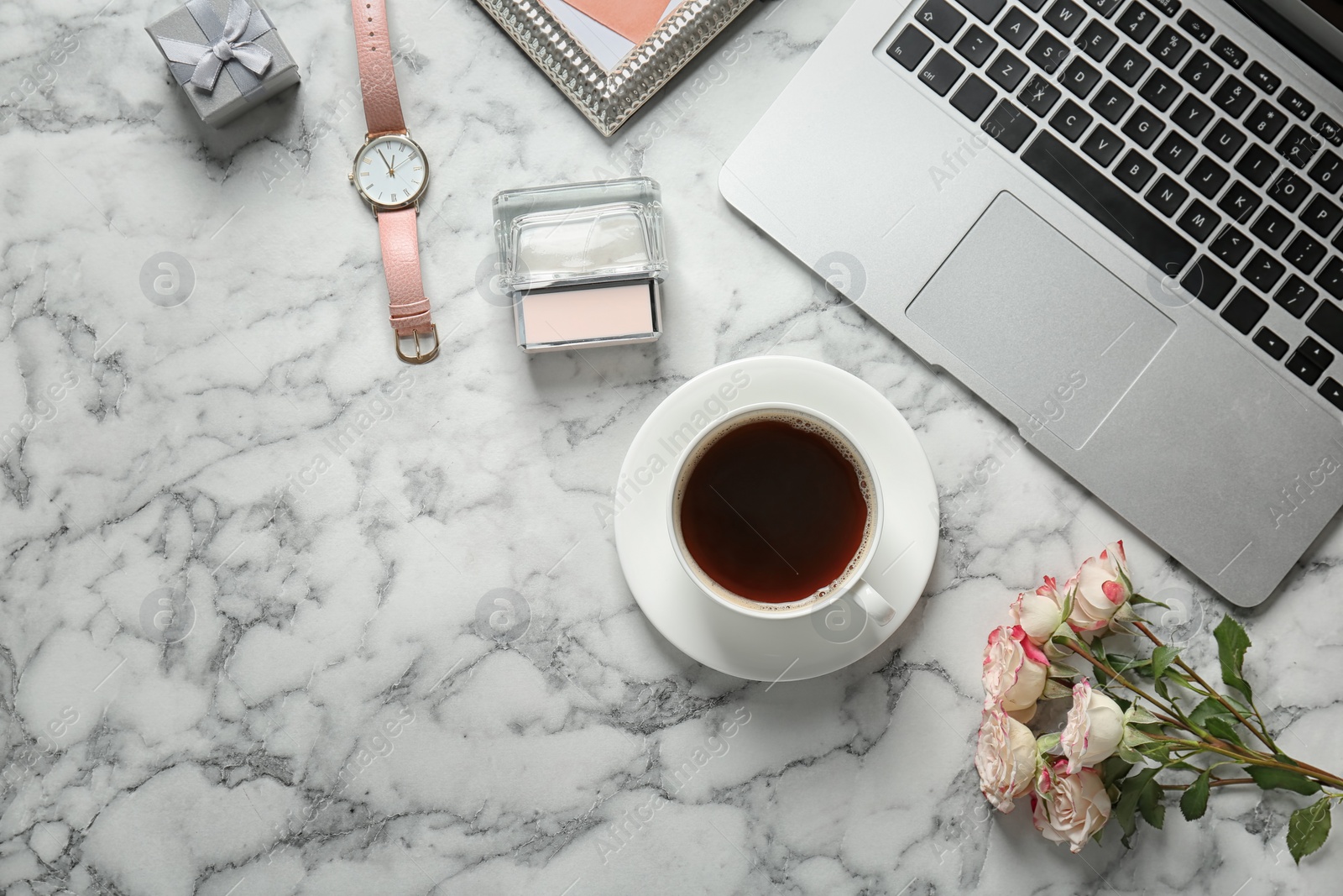 Photo of Flat lay composition with laptop, cup of coffee and stylish accessories on marble background. Blogger concept