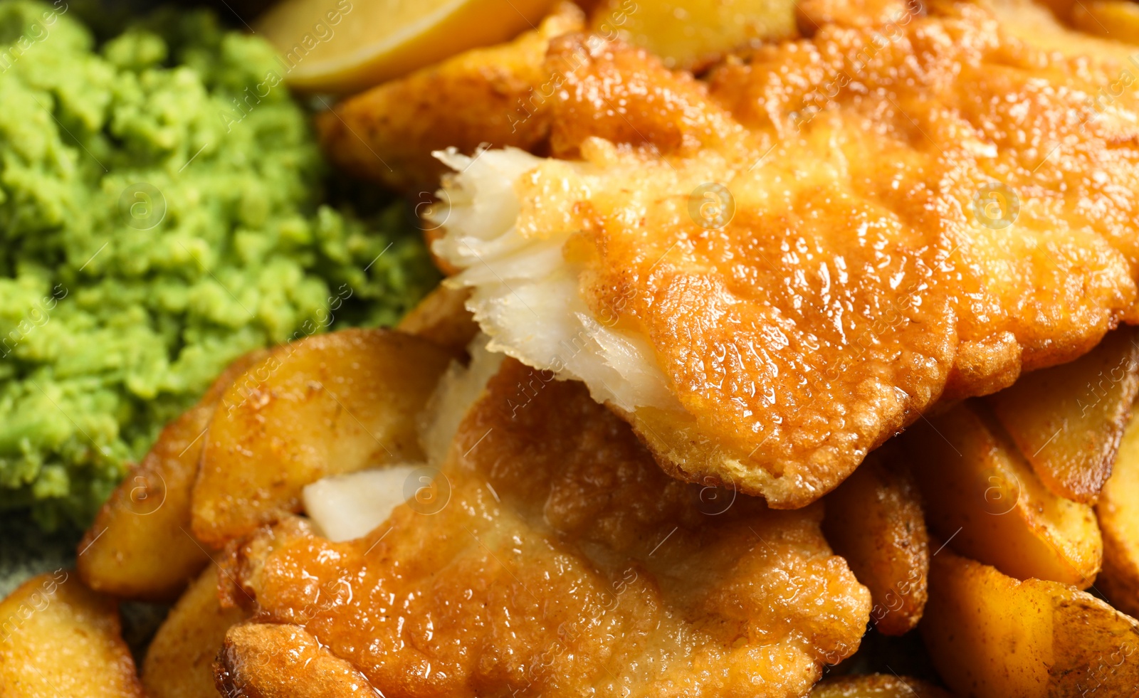 Photo of British traditional fish and potato chips, closeup