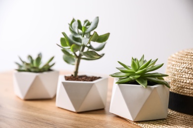 Photo of Beautiful succulents on wooden table, closeup. Interior decoration