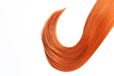 Photo of Beautiful strand of straight red hair on white background, top view. Hairdresser service