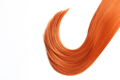 Beautiful strand of straight red hair on white background, top view. Hairdresser service