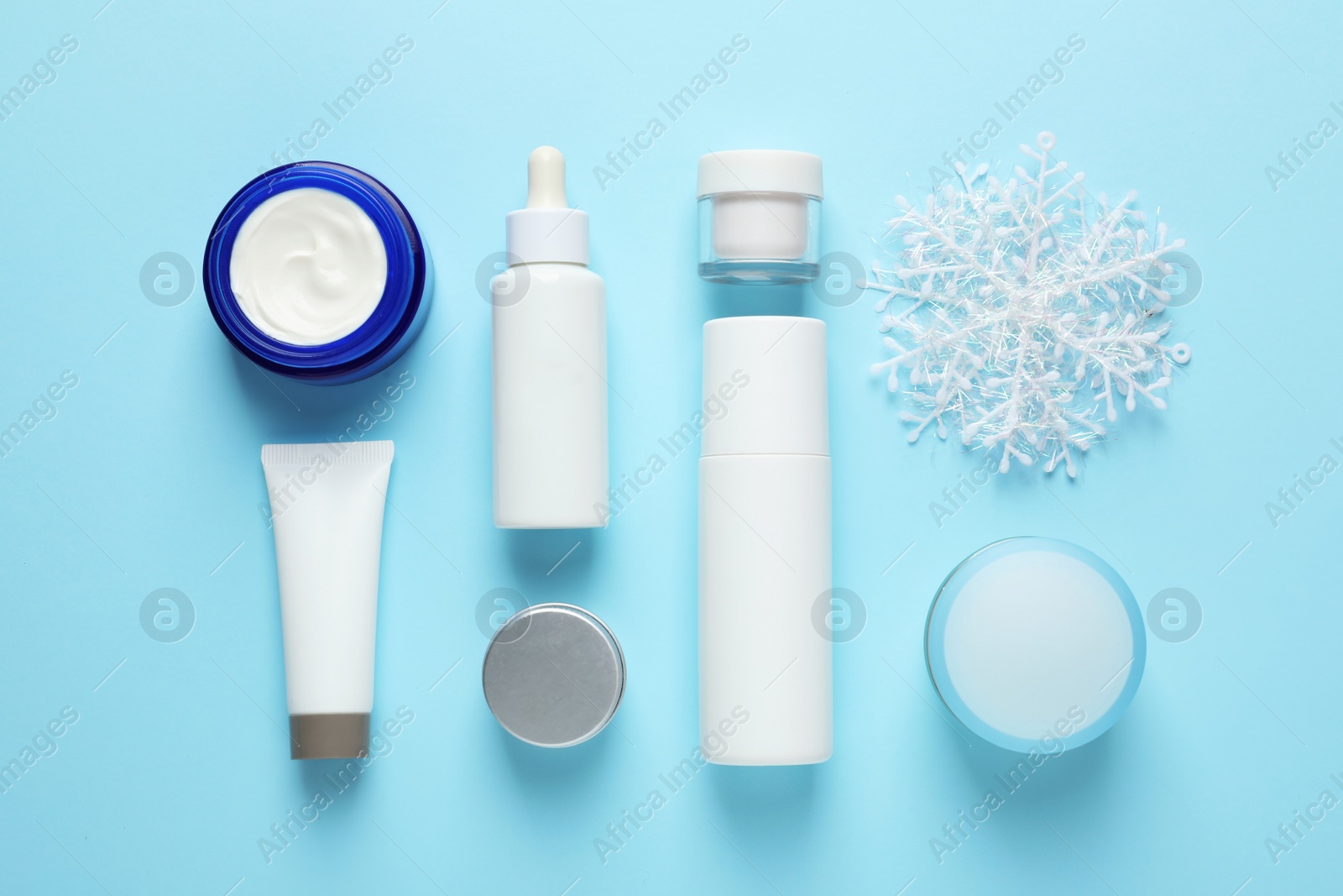 Photo of Set of cosmetic products on blue background, flat lay. Winter care