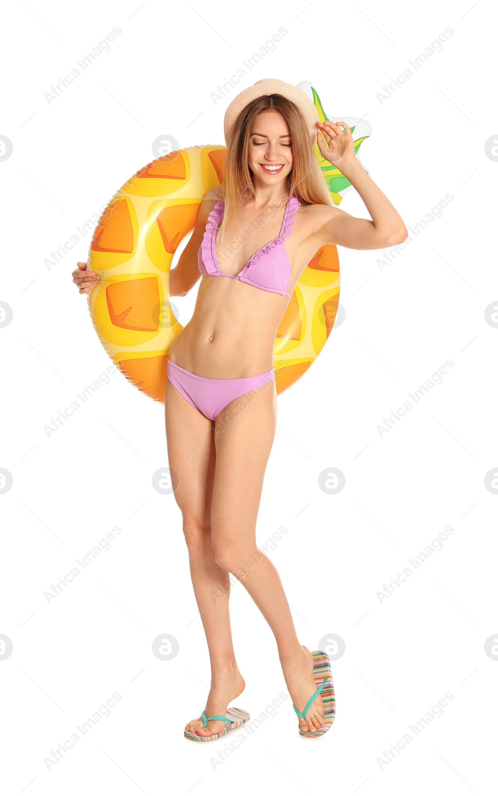 Photo of Beautiful young woman in stylish bikini with pineapple inflatable ring on white background