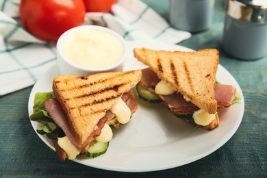 Photo of Delicious sandwiches with vegetables, ham and mayonnaise on plate, closeup