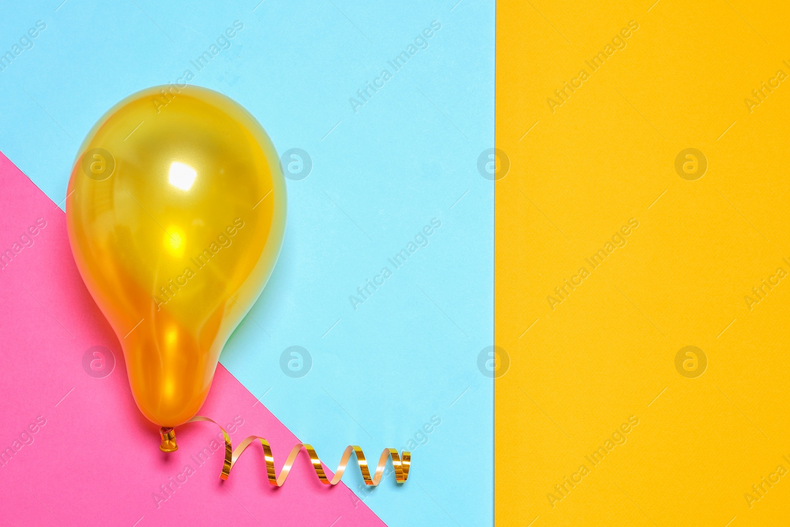 Photo of Bright balloon on colorful background, top view with space for text. Party time