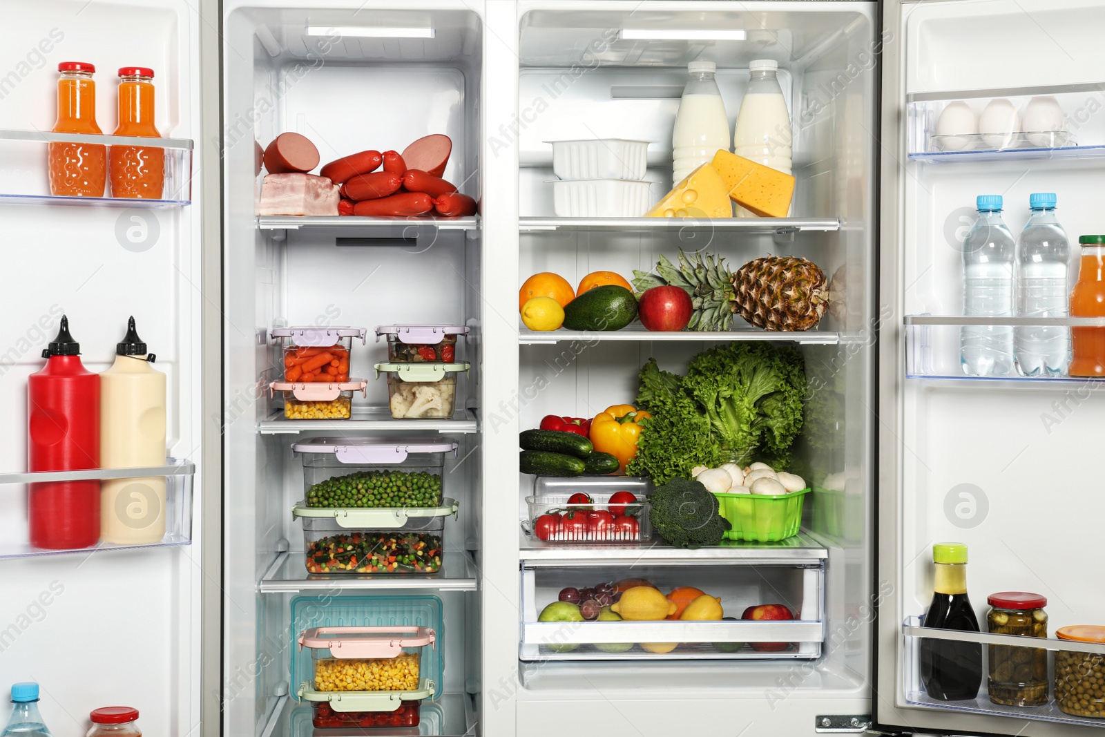 Photo of Open refrigerator full of different fresh products