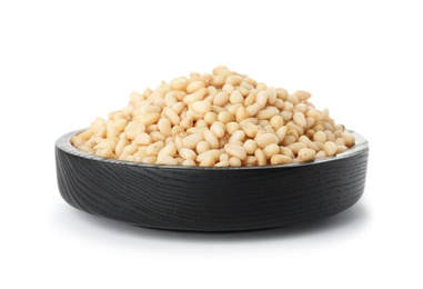 Plate with pine nuts on white background