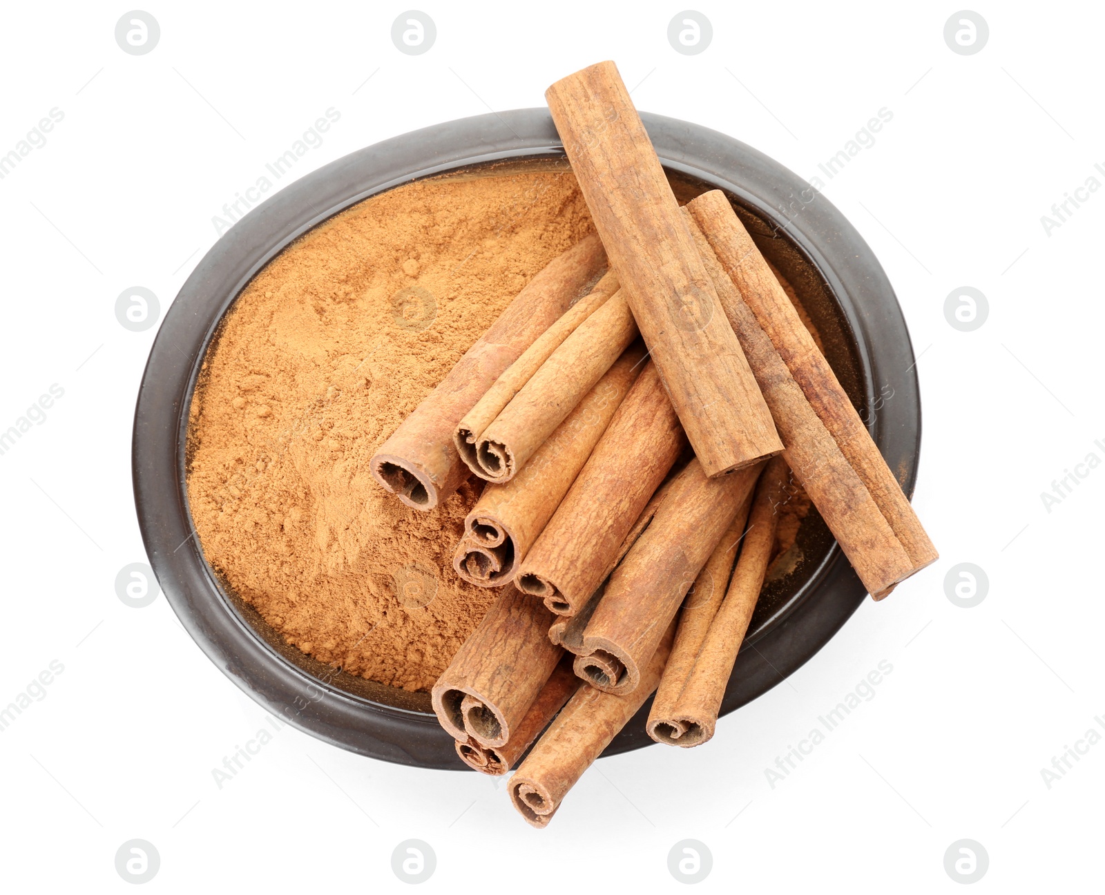 Photo of Bowl with aromatic cinnamon sticks and powder on white background