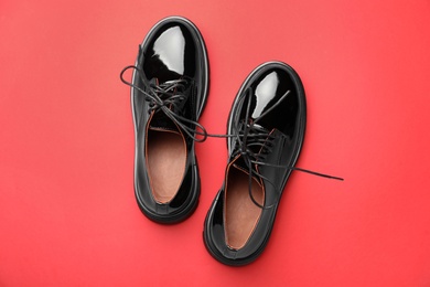 Pair of stylish female shoes on red background, flat lay