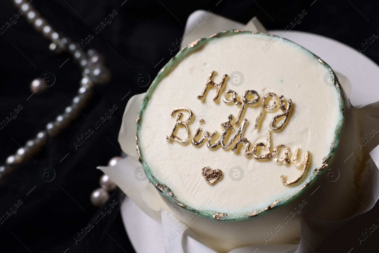 Photo of Delicious decorated Birthday cake on black background, closeup